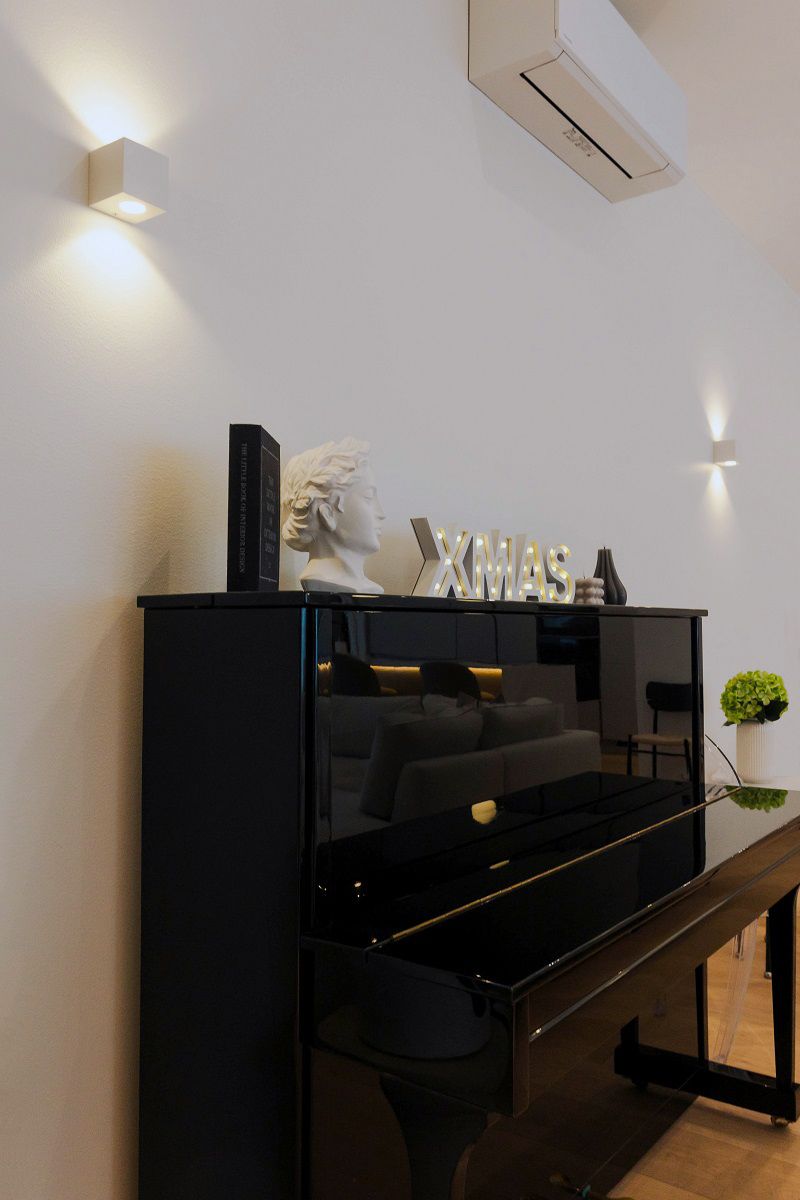 CUBIC 2 wall lamps in the living room on both sides of the piano.